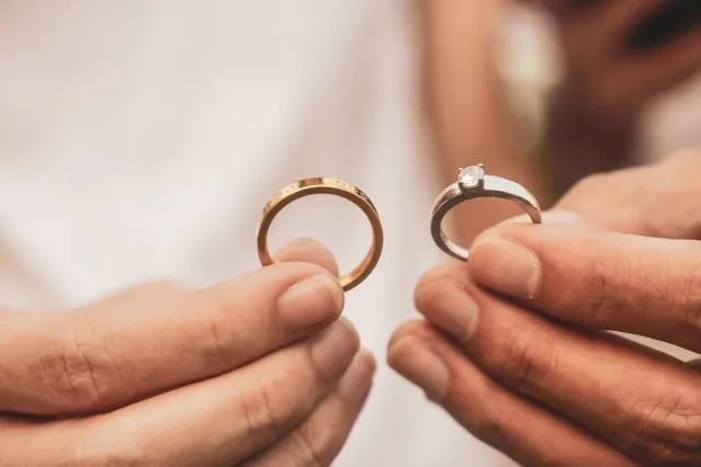 Two rings being held up and compared