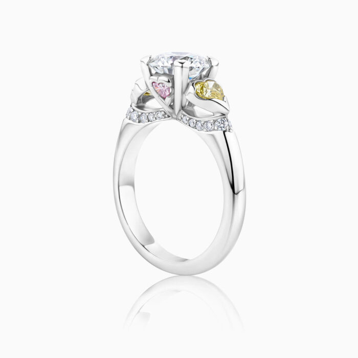 side view 3 stone engagement ring with white , yellow and pink diamonds in platinum